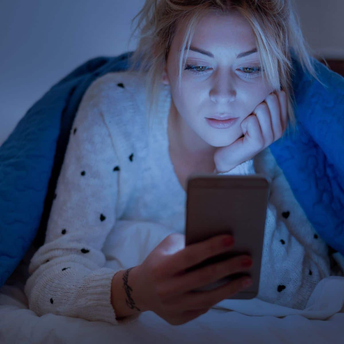 woman staying up late on her phone