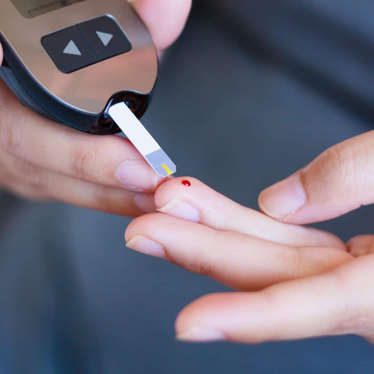 woman taking her blood sugar due to diabetes