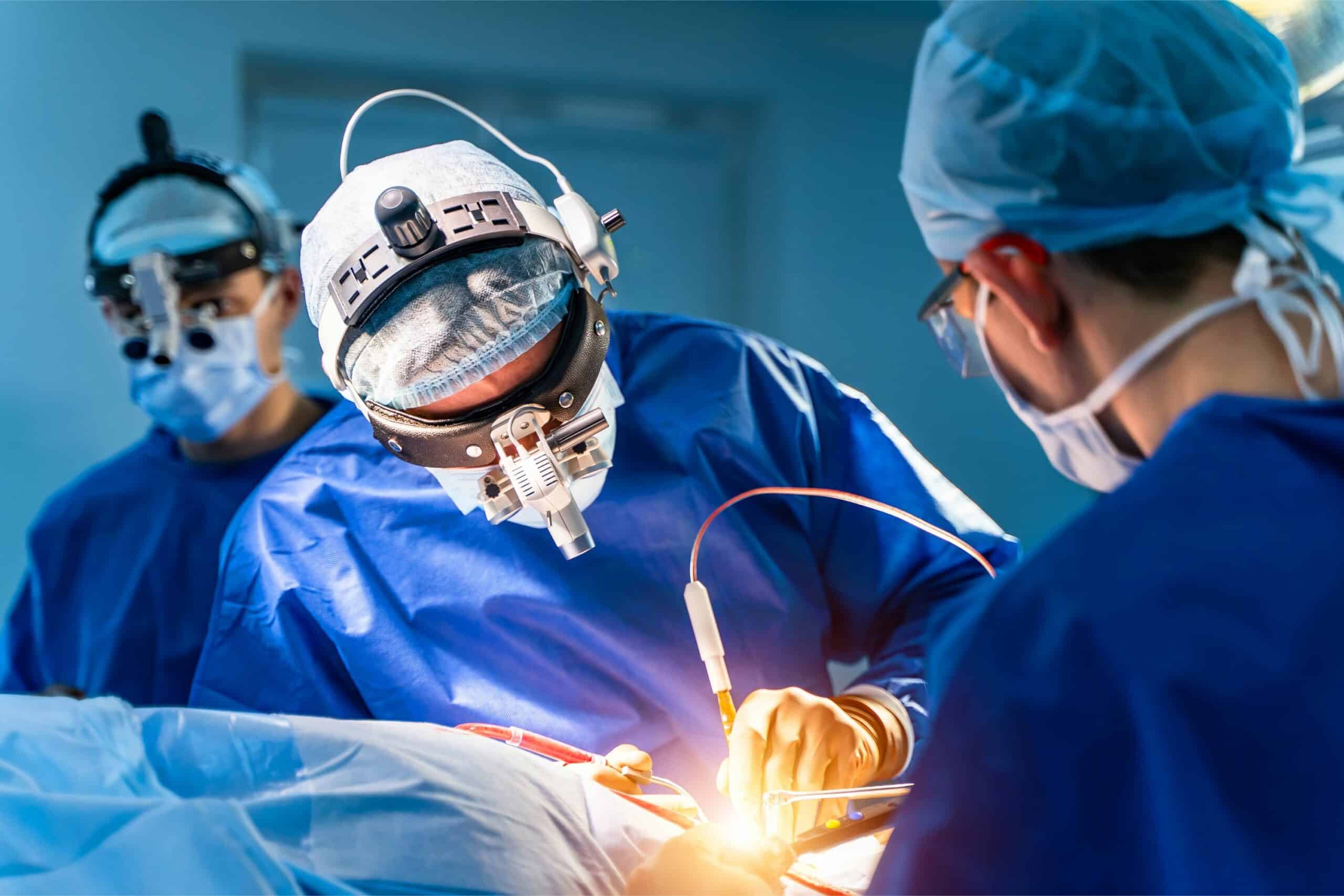 two doctors performing open heart surgery on a patient